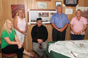 Renner Springs Roadhouse owners Alan and Christine Rendell on either side of the Borella VC memorial board, with staff members (from left); Alix Robinson, Arthur Young and Yvette Dayes,